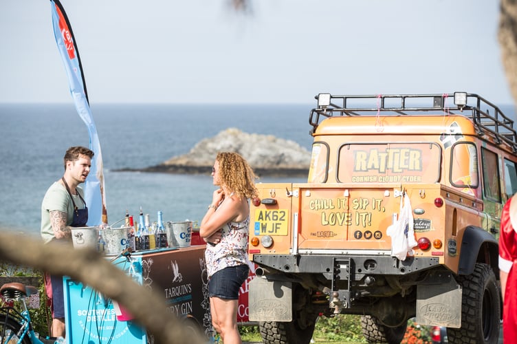 An Ale Festival attendee ordering a drink against the seaview from the Bowgie Inn