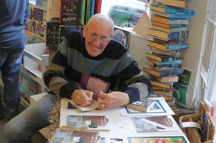 Brian signing copies of his book 'A Peek into Liskeard's Past'