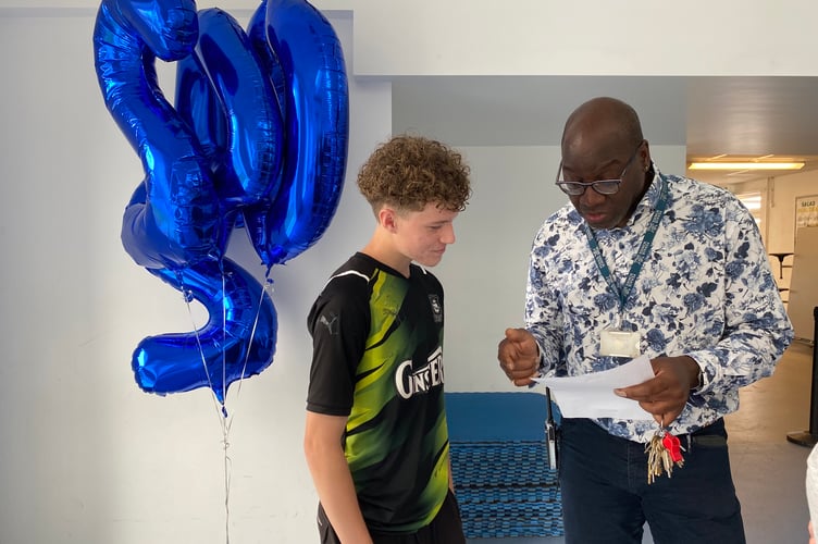 Penair School's Mr Sharpe and with student Tyler Best on GCSE results day