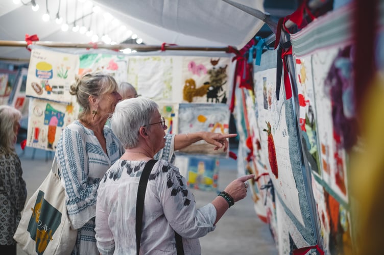 Visitors looking at panels from Story Shelter at East Pool Mine(C)National Trust Images_Steve Haywood