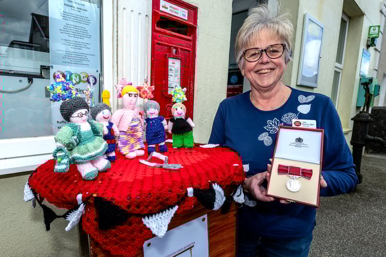 Sally Bourton with her medal and the special yarn-bombing gift. Picture: Paul Williams