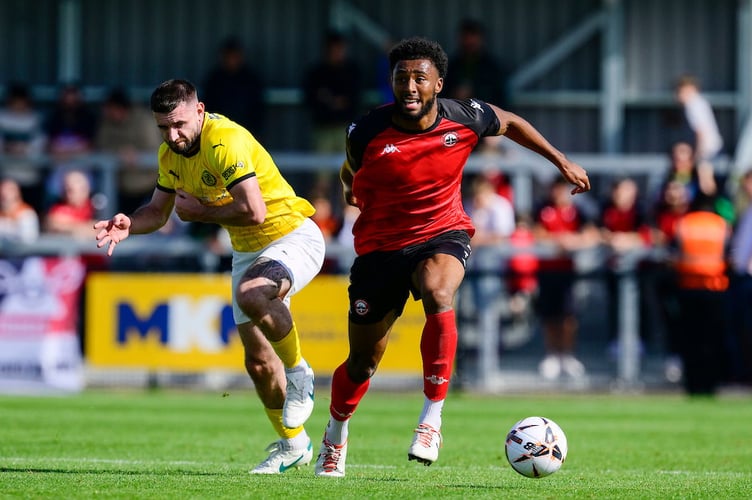 Pharrell Johnson of Truro City holds off Danny Newton of Brackley Town during the Emirates FA Cup 2nd round qualifying tie match between Truro City and Brackley Town at Truro Sports Hub on 14 September 2024 Photo: Phil Mingo/PPAUK