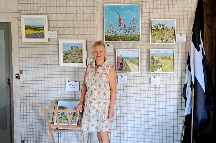 Marina Rule alongside her paintings at Botallack Count House. Credit National Trust Images Jade Bone