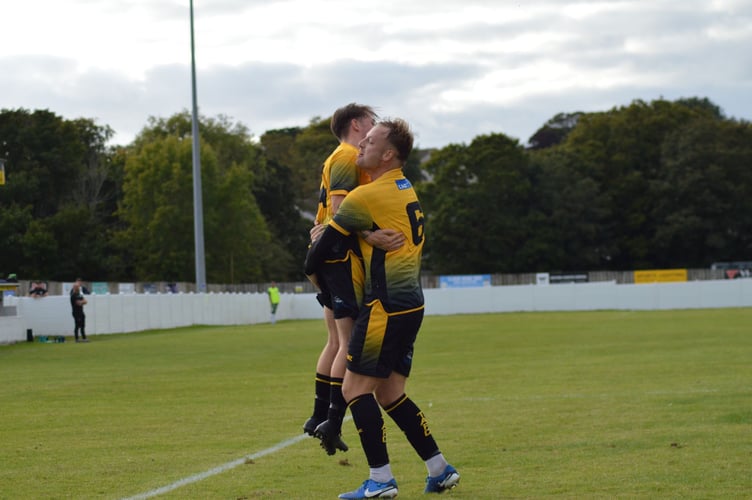 Harry Jeffery (mid air) and the returning Elliott Crawford celebrate Torpoint's third goal against Street on Saturday. Picture: Matt Burgoyne