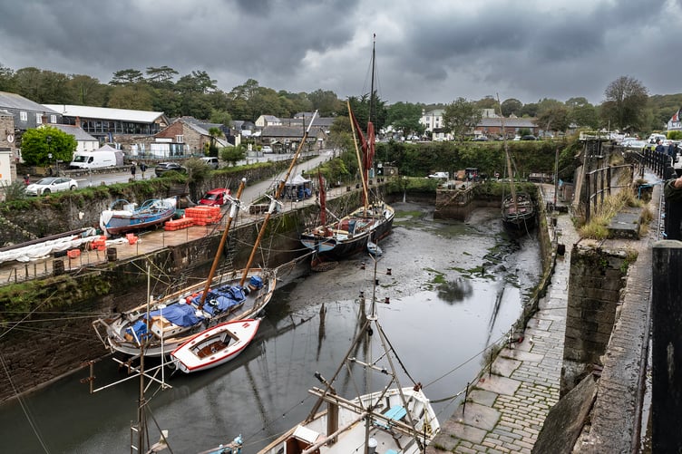 Water has flowed out of the inner harbour leaving vessels resting or listing on the mud and silt. Picture: Paul Williams