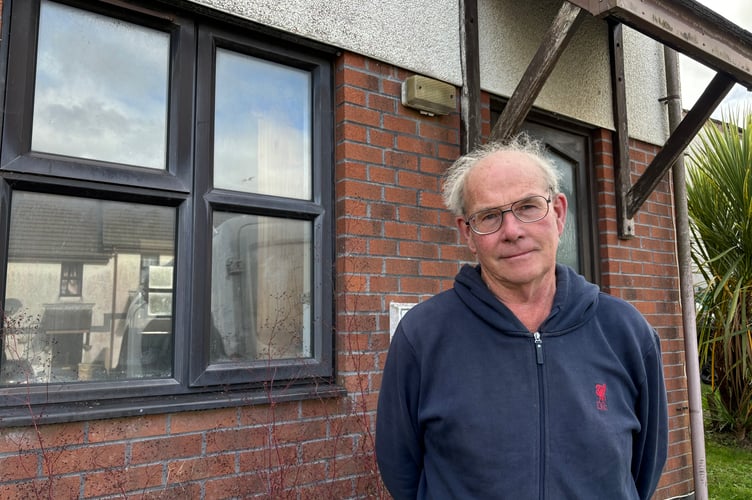 Veryan parish councillor Luke Dunstone outside the empty house 