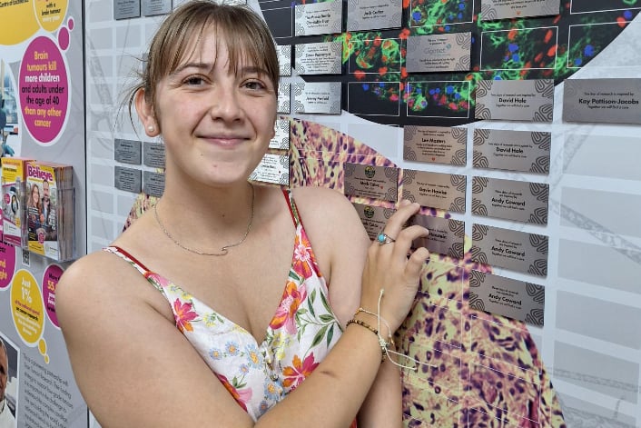 Alisha at the wall of hope in the Brain Tumour Research Centre of Excellence at the University of Plymouth.