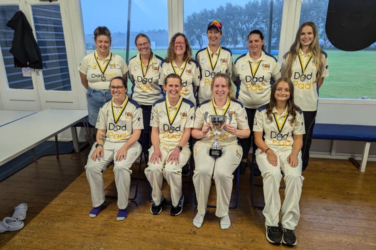 Truro celebrate their success with skipper Izzy Newell holding the trophy. Picture: Truro Cricket Club