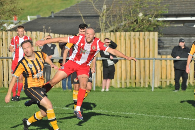 Newquay striker Louis Price (red) enjoyed a fine afternoon at Tiger Way, helping himself to five goals. Picture: Steve Rich