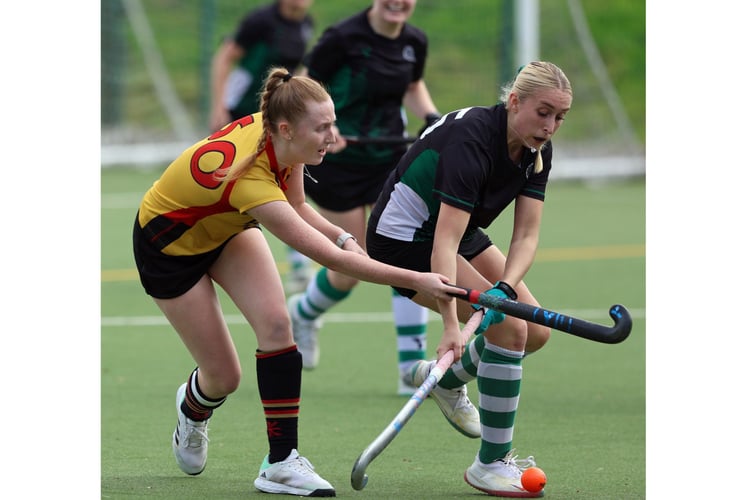 Caradon's Katie Fear (yellow) plays the ball forward at Lux Park on Saturday. Picture: Glen Rogers