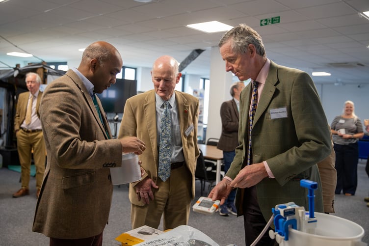 ShelterBox CEO Sanj Srikanthan shows Cornwall's Lord Lieutenant and his deputies the type of aid items the organisation uses around the world