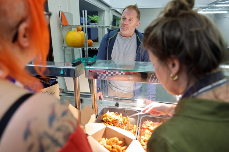 Wayne Sanders is served a hot meal by Street Food Project volunteers. Run by Growing Links CIC, Street Food Project is welcoming some of the communityâs most vulnerable people into its brand new premises at the Safe & Well Hub, the former John Daniel Centre in Heamoor. Growing Links CIC was awarded £8,313 of grant funding from Penzance Council to buy and install a commercial kitchen in the building. Photo by Penzance Council.