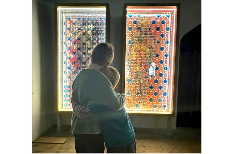 Youngsters viewing two of the illuminated panels at St Ewe Parish Church.