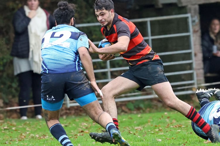 Liskeard-Looe winger Alex Kendall, who was playing his final match before going travelling to Australia, looks to beat Bodmin inside-centre Gagandeep Bali. Picture: Glen Rogers