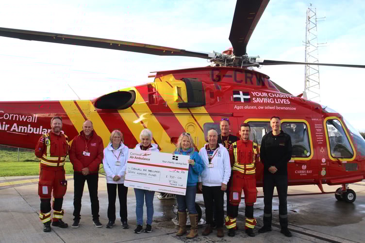 St Ives Tennis Club members present their cheque to the Cornwall Air Ambulance crew.
