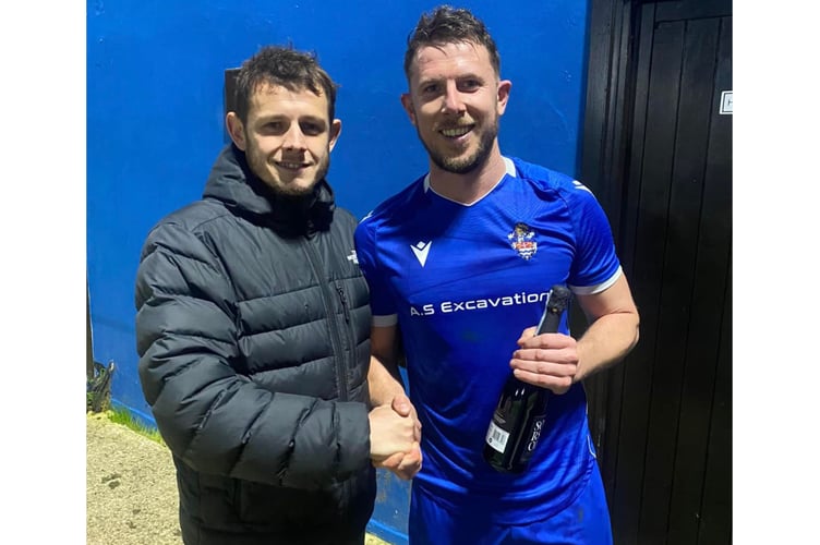 Lloyd Scaife is presented with Bude Town's man of the match award against Newquay by former striker Billy Hopcroft. Picture: Bude Town AFC