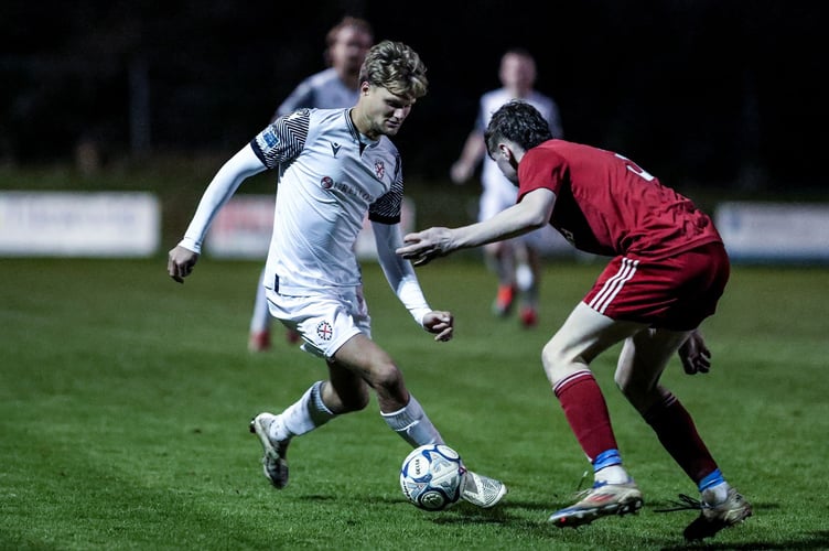 St Austell's man of the match, attacker George Marris, drives at the Barnstaple defence. Picture: Paul Williams
