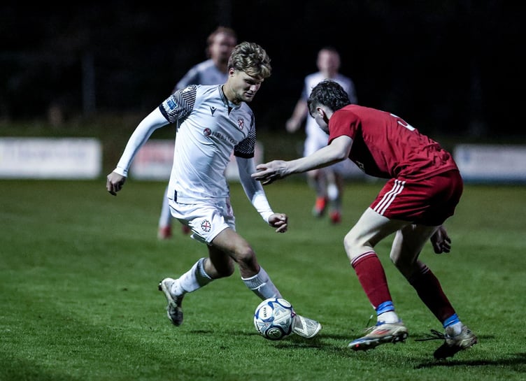 St Austell's man of the match, attacker George Marris, drives at the Barnstaple defence. Picture: Paul Williams