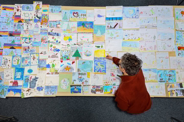 Mayor of Penzance, Stephen Reynolds chooses a winner from the 175 entries for his annual Christmas Card Competition. Photo by Penzance Council.