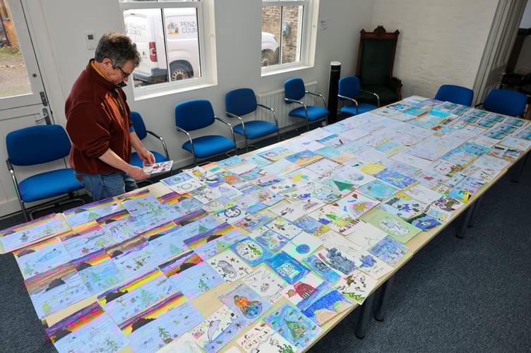 Mayor of Penzance, Stephen Reynolds chooses a winner from the 175 entries for his annual Christmas Card Competition. Photo by Penzance Council.