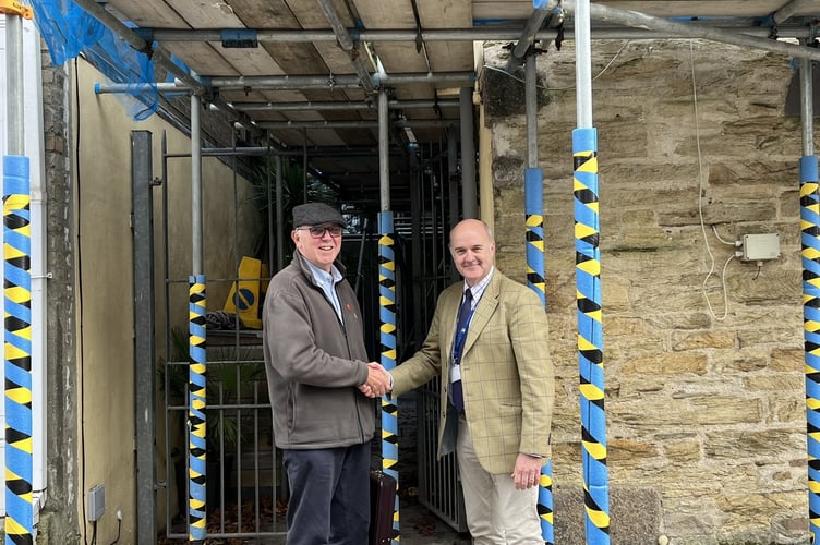 Grant recipient Tony Martin shaking hands with Truro City town clerk David Rodda
