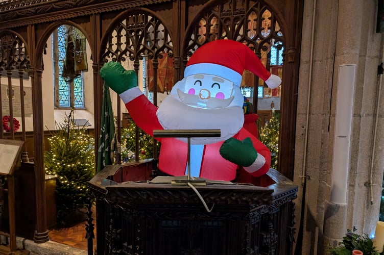 An inflatable Santa is present and has taken to the pulpit to spread his Christmas cheer. (Picture: Aaron Greenaway)