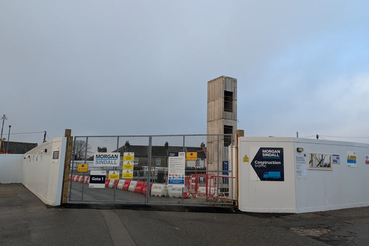 A LIFT shaft rises up out of the former Cattle Market car park in Liskeard: it will be part of Cornwall Council’s new Integrated Services Hub. Cottages in Varley Lane are visible in the background. The Council says that groundworks and services connection are progressing well, but that issues encountered by the contractor could push completion into 2026