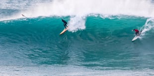 Surfers ride giant walls of water at the Cribbar