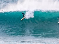 Surfers ride giant walls of water at the Cribbar