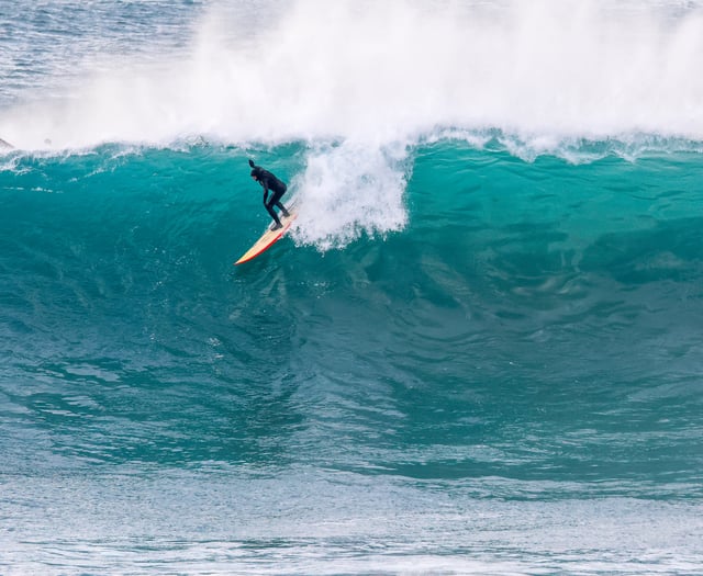 Surfers ride giant walls of water at the Cribbar