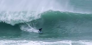 Surfers tackle huge waves at the Cribbar