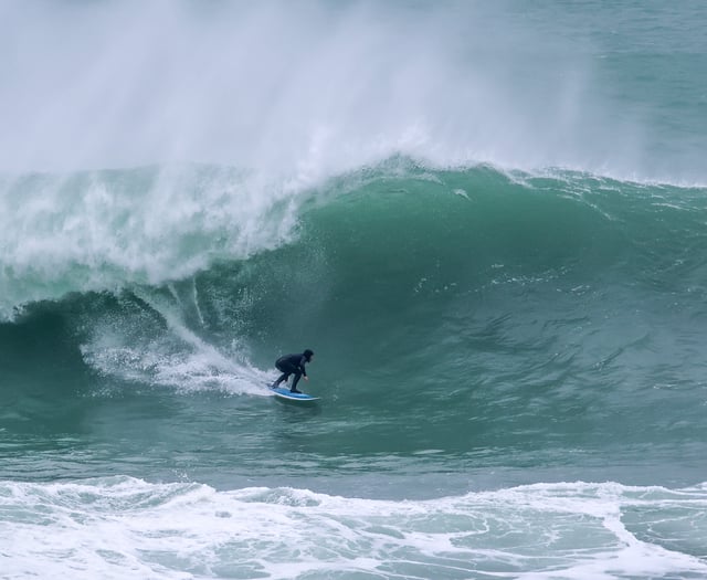 Surfers tackle huge waves at the Cribbar