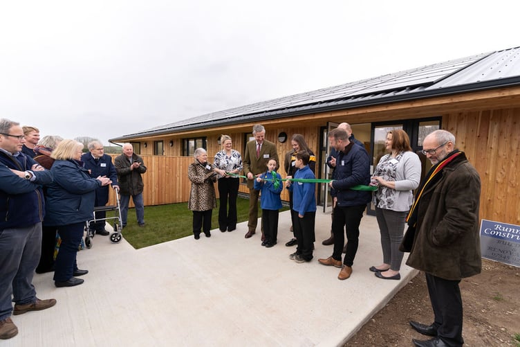 Amy Bunt cuts the ribbon to declare the new community centre open while invited guests and dignitaries join in the celebrations (Picture: Frankie Thomas)