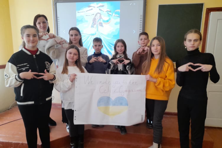 STUDENTS at a school in Tseliv, Ukraine, pose for a photo to show their gratitude to volunteers in Cornwall