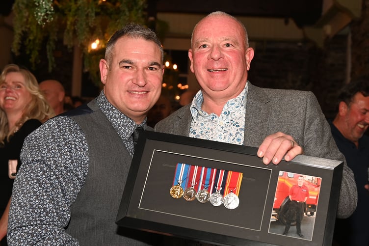 Presenting medals with great pride to Lee Griffin, group manager of east command of the Cornwall Fire and Rescue Service is Stuart Parkyn, station manager at Cornwall Fire and Rescue Service (Picture: Adrian Jasper)