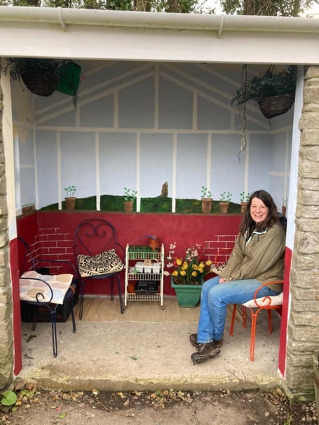 Sarah Worne sitting in the bus stop after finishing her latest design. The 'world's coolest bus stop' has been given its latest makeover - by locals who have been doing it up for 20 years. The Fowey Pretty Bus Stop on Lankelly Lane in Cornwall has been decorated and painted by residents for two decades. It was given its first makeover by Jane Tinsley - after it became a target for anti-social behaviour. Over the next 20 years the stop it has been decorated as a tea room, a yacht race, and last year celebrated the 200th anniversary of the RNLI. 