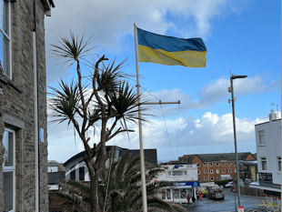 Ukrainian flag raised to mark invasion anniversary