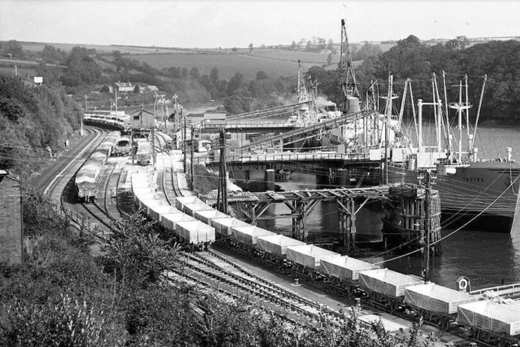 Barrie says of this picture: “Part of the massive docks at Fowey in its heyday. The houses in the background are in Mixtow. All of the railway tracks are buried or removed. It is now one massive area of concrete used by Imerys lorries, transporting clay.”