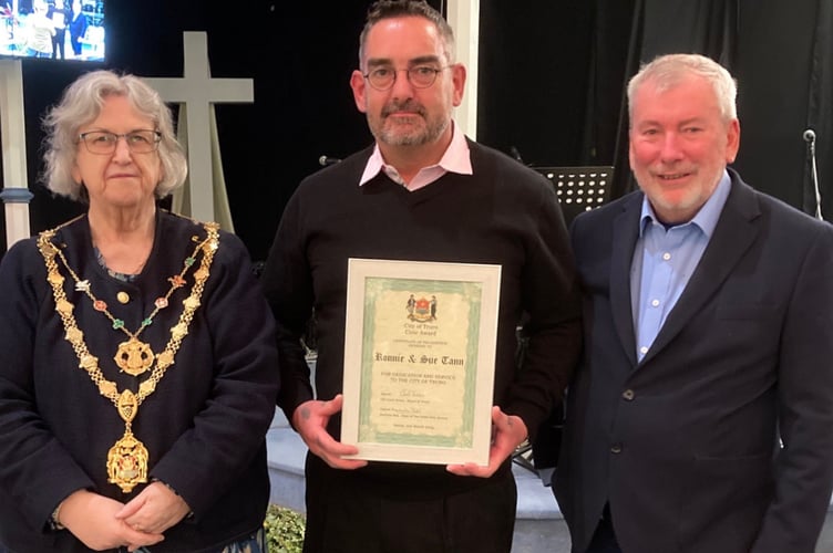 John Tann receives his parents' posthumous award from Cllr Carol Swain and Malcolm Bell 