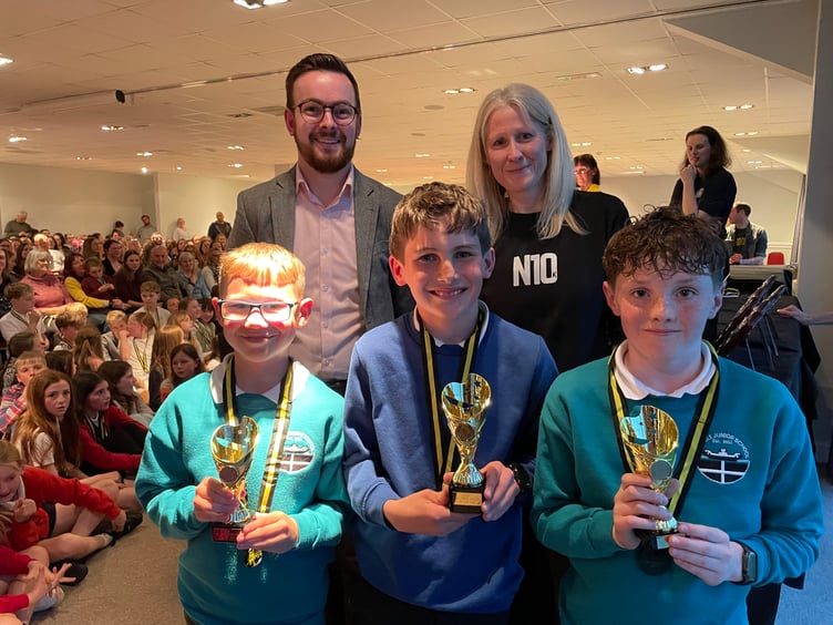 Year 5/6 award winners Rafe Jackson (Duloe), Alfie Nicholson 
 and Micah Martin (Carbeile) alongside Josh Mitchell from Parkes & Pearn Estate Agents and East Cornwall Harriers chairman Lucy Oldham