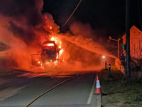 Firefighters tackle car transporter engulfed in flames