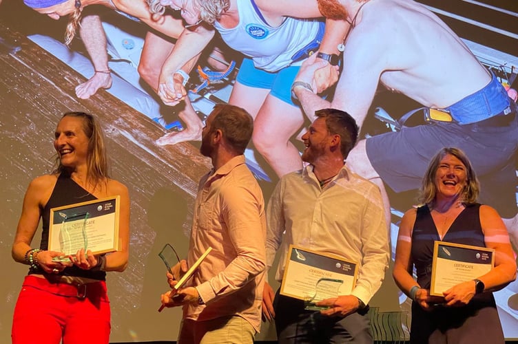 The Oars of Thunder are all smiles as they collect their certificates and awards for finishing first in the Mixed Class of the World's Toughest Row