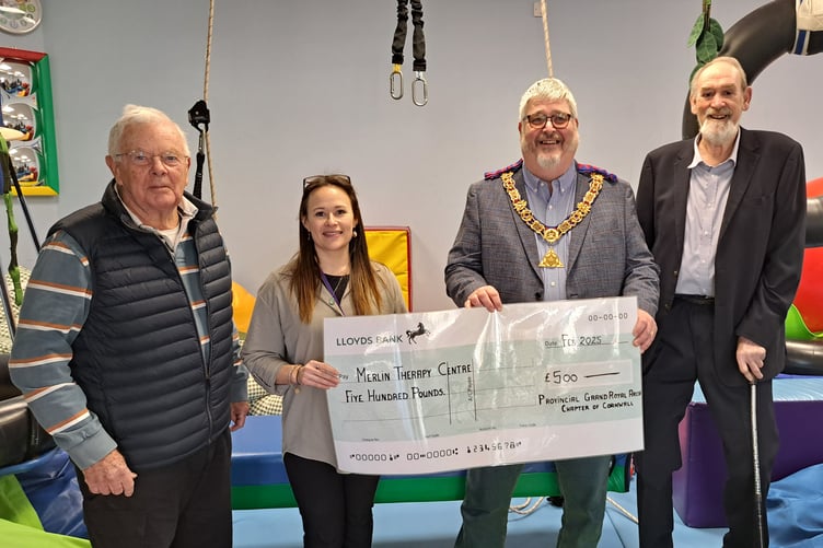 Freemasons present a giant cheque to the Merlin Centre.