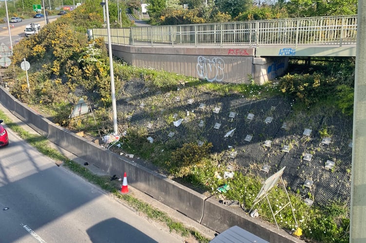 An area around the footbridge next to the Carkeel Roundabout has litter, abandoned trolleys and graffiti