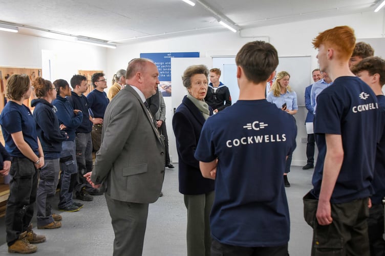 Neil Payne from Cornwall Marine Network introduces HRH The Princess Royal to boatbuilding apprentices, Ollie Brand and Harley Billington.