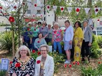 Inner Wheel turn flower bed into sea of knitted red poppies