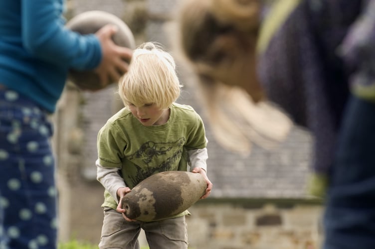 Playing a traditional game of "Kayling" a sort of garden skittles at Trerice, Cornwall.