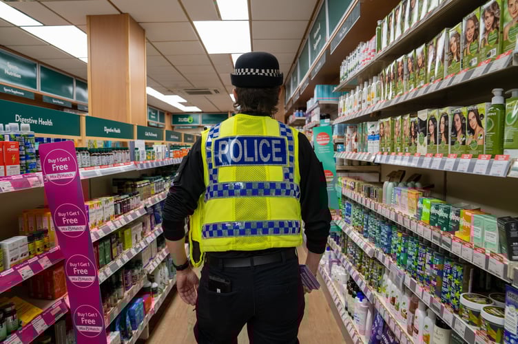 officer walking through a shop.