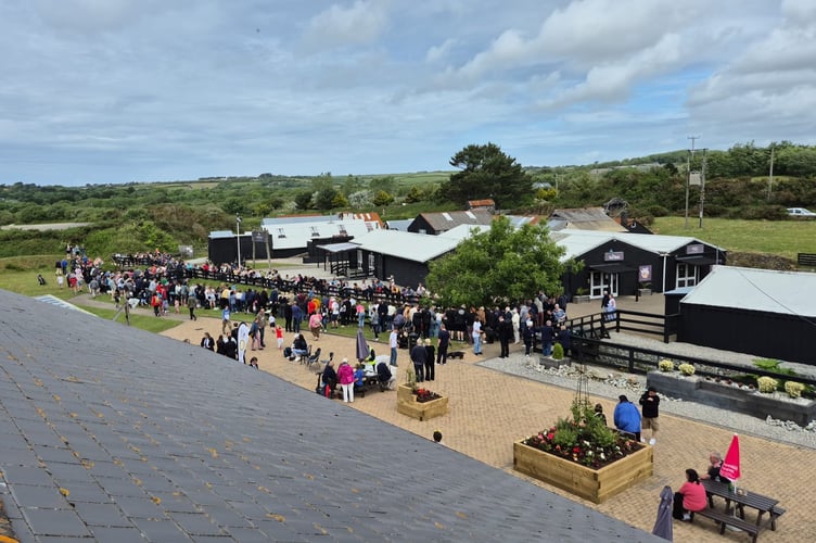 Crowds watching the duck race at Cornwall Gold.