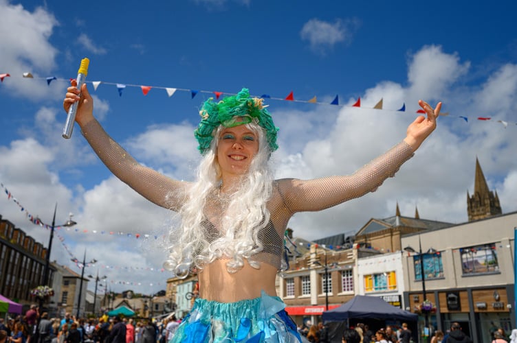 A stilt walker at Children's Day, Truro